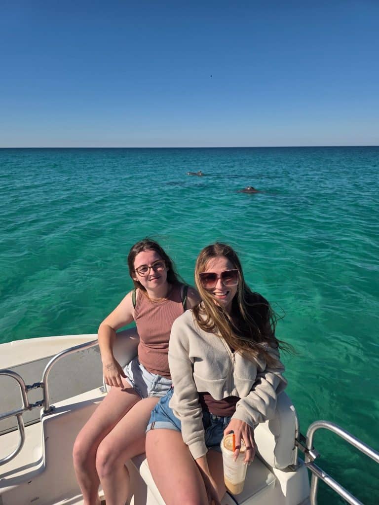 Guests spotting dolphins from a private boat during a shell island and dolphin excursion in panama city beach